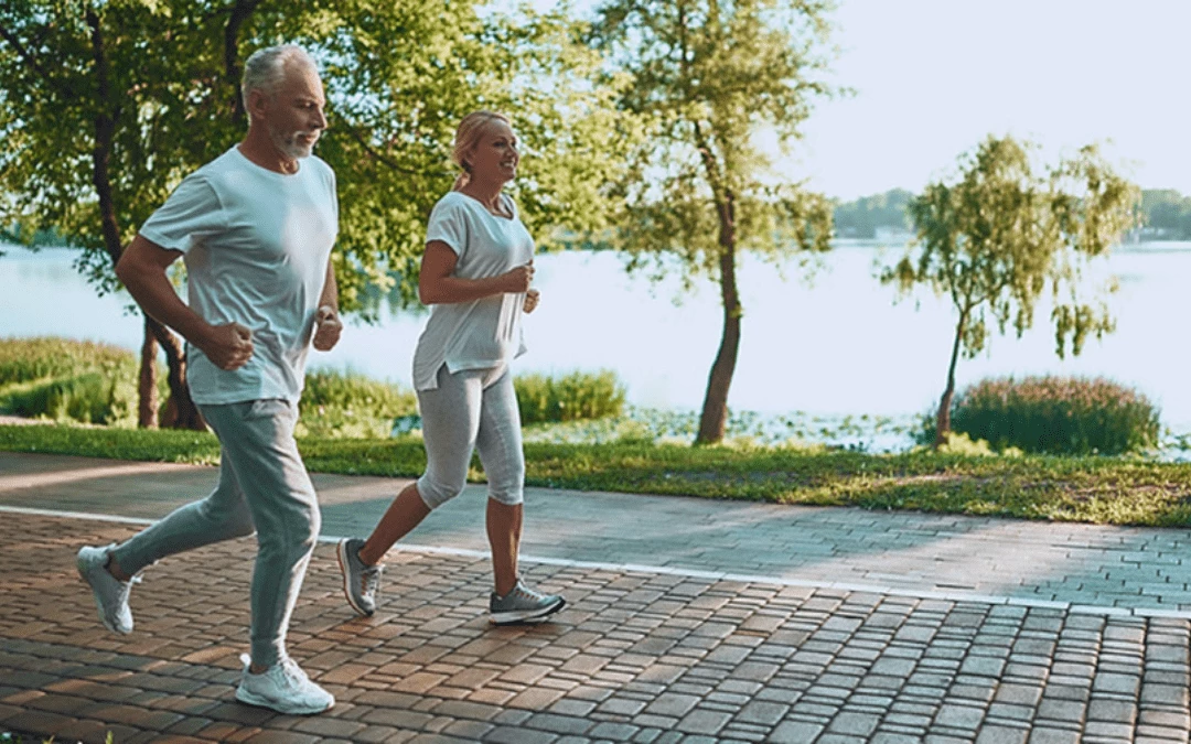 Happy Smiling Middle Aged Couple Running Jogging Together At The Park