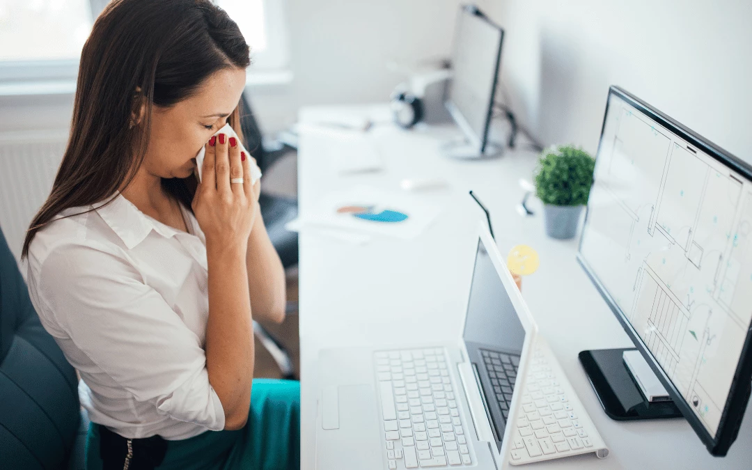 Working Woman Blowing Her Nose With Tissue While Working In Front Of Computer In Office