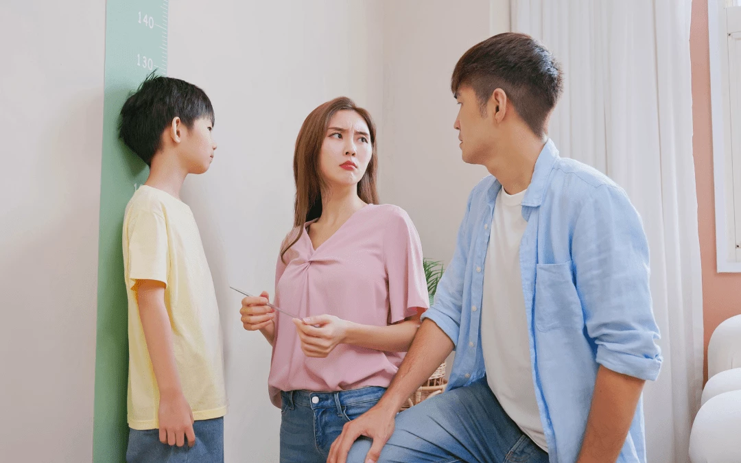 Mom And Dad Upset That Son Is Short When Standing On The Wall Measurement Ruler