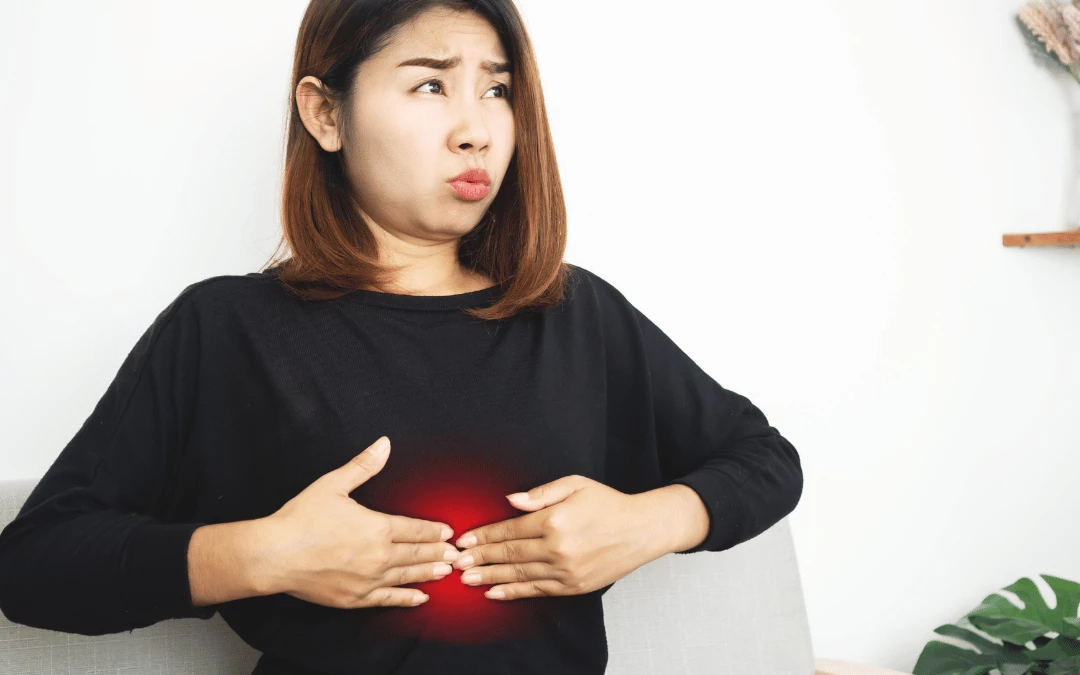 Woman Showing Discomfort Face With Both Of Her Hand Pressing On Her Stomach