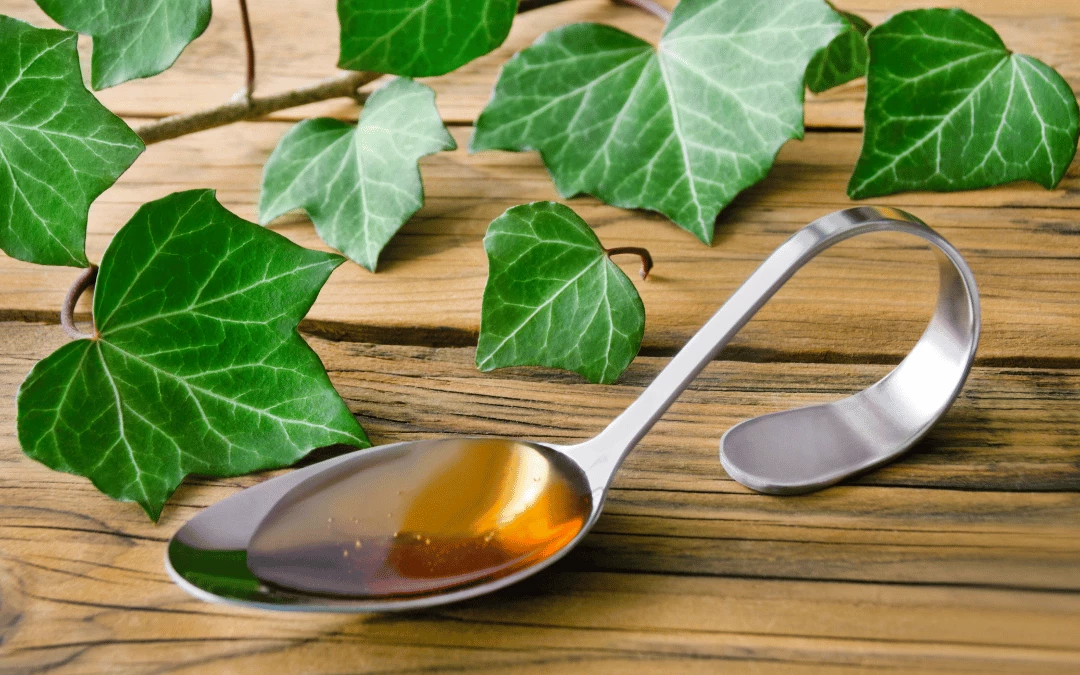 ivy-leaf-plant-with-ivy-leaf-cough-syrup-on-wooden-table-upclose